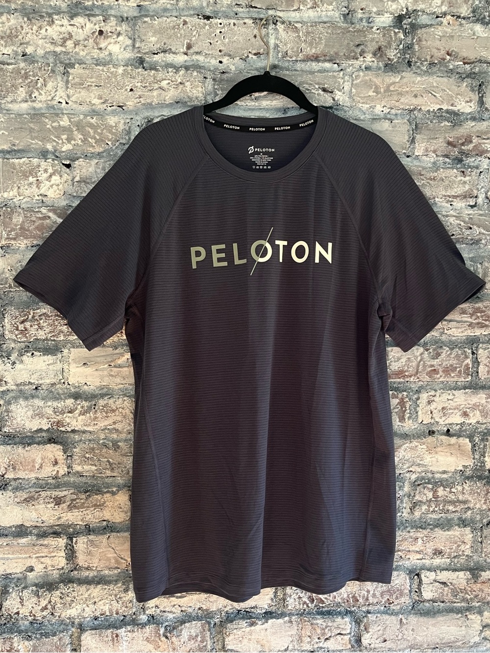 Peloton Dark Blue/Charcoal Logo Tee in excellent condition. Ribbed material feel